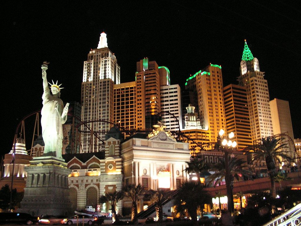 The New York-New York casino on the Las Vegas Strip lit up at night, with a Statue of Liberty replica and towers