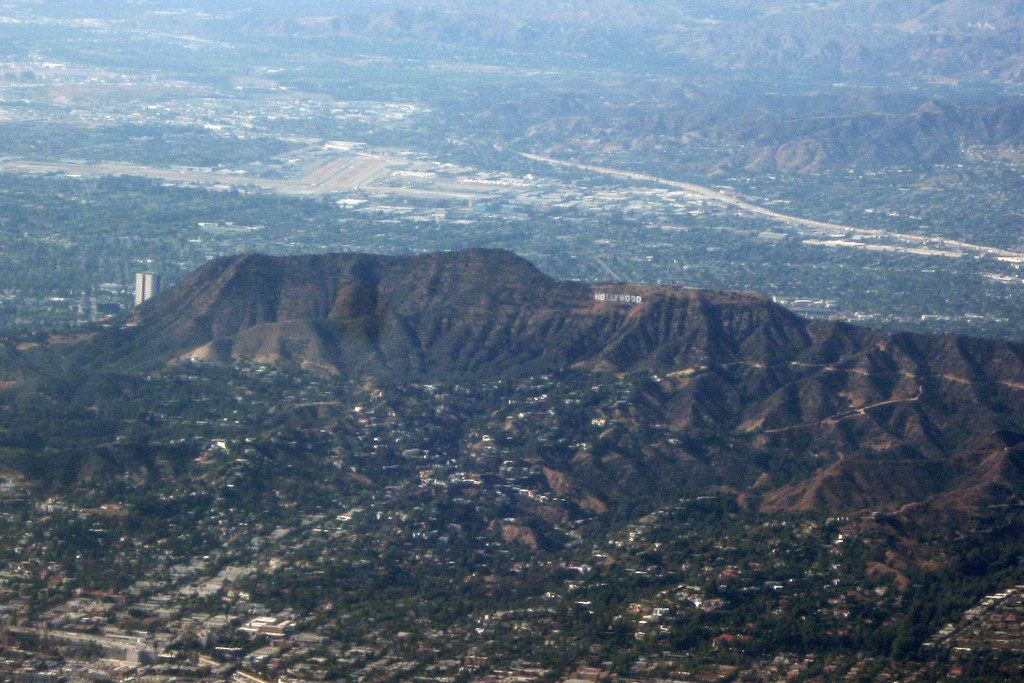 Aerial view of the Hollywood Hills with the Hollywood sign, hillside homes and the sprawling city beyond