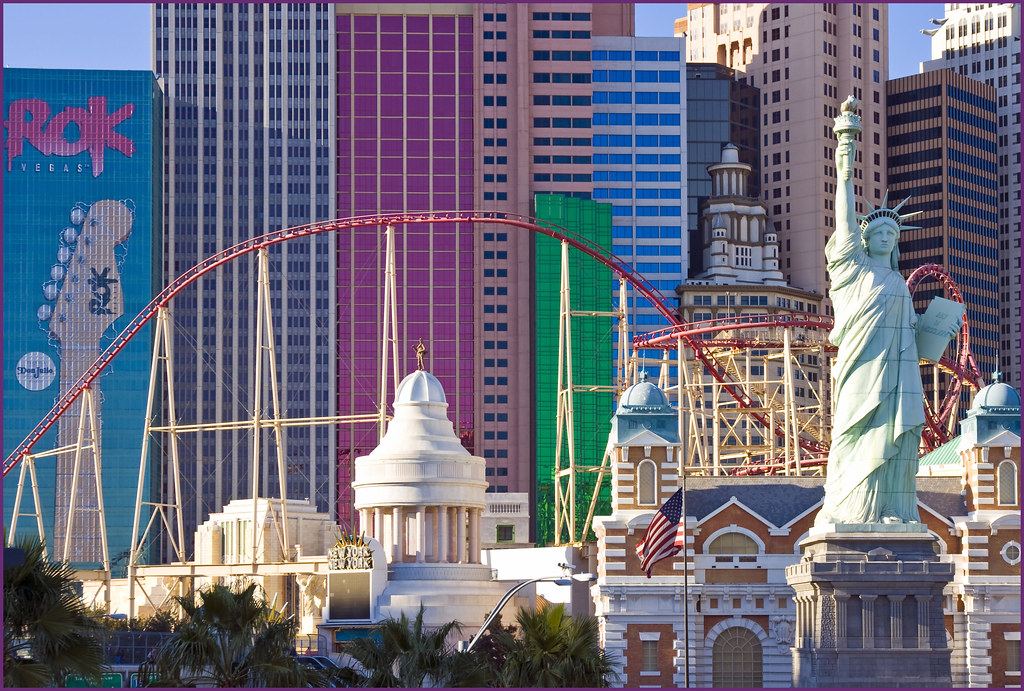 Statue of Liberty replica, a red roller coaster and colorful high-rise towers along the Las Vegas Strip