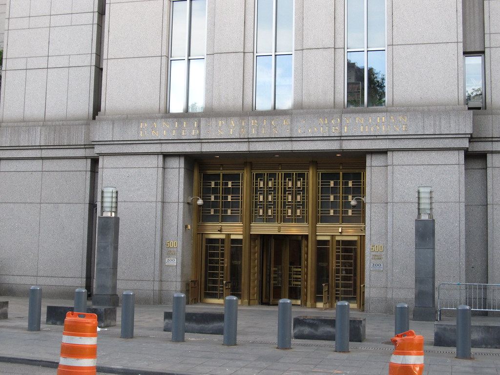 Entrance of the Daniel Patrick Moynihan United States Courthouse in Manhattan, with bollards and orange traffic barrels