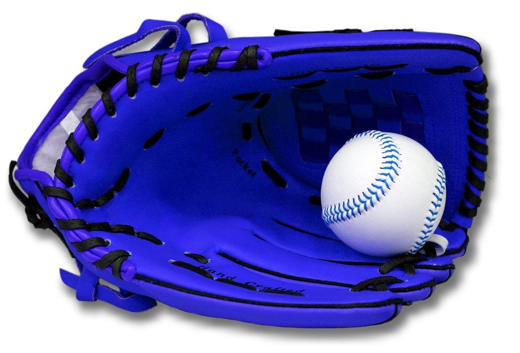 A blue leather fielding glove with black laces holding a white ball with blue stitching