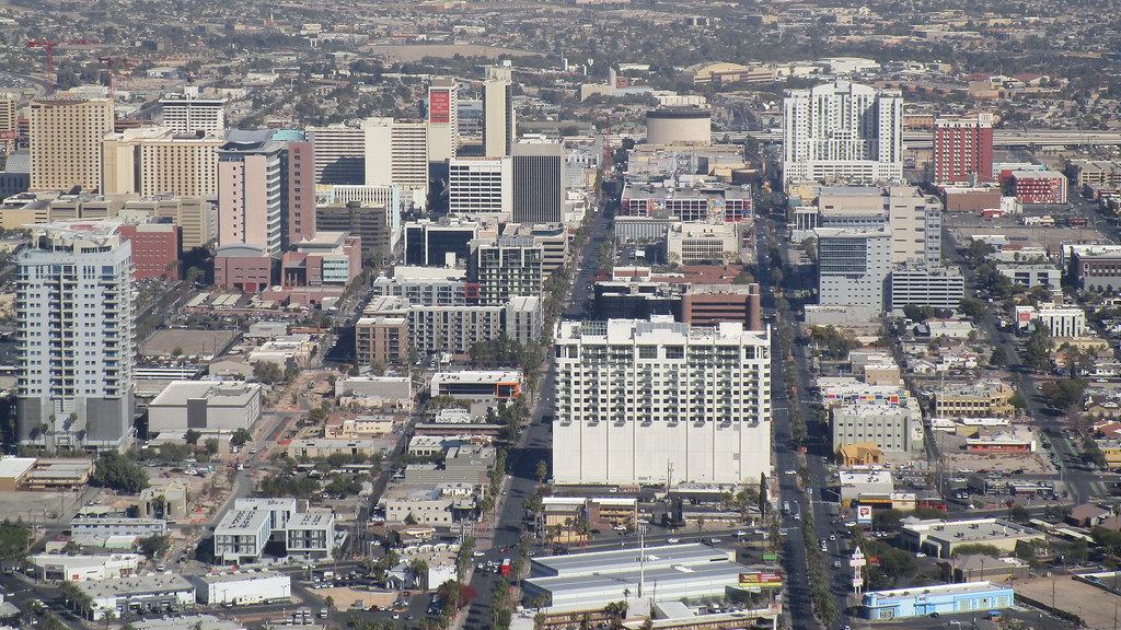 Aerial view of downtown Las Vegas with high-rise buildings and long streets stretching toward the horizon